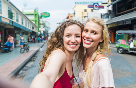 Couple of beautiful girls visiting bangkok main attractionsの写真素材