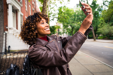 Happy african american woman smiling. Beautiful young female walking and having fun in New York city
