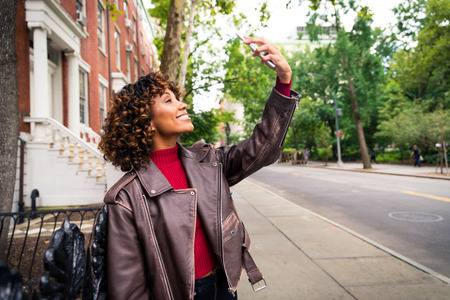 Happy african american woman smiling. Beautiful young female walking and having fun in New York city