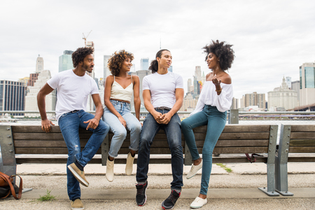 Group of afroamerican friends bonding in Manhattan, New York - Young adults having fun outdoors, concepts about lifestyle and young adult generationの写真素材