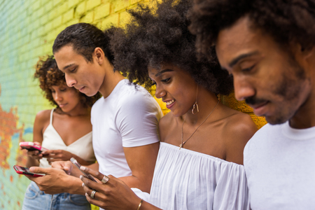 Group of afroamerican friends bonding in Manhattan, New York - Young adults having fun outdoors, concepts about lifestyle and young adult generationの写真素材