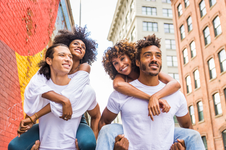 Group of afroamerican friends bonding in Manhattan, New York - Young adults having fun outdoors, concepts about lifestyle and young adult generationの写真素材