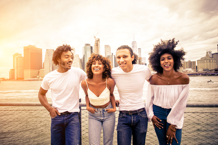 Group of afroamerican friends bonding in Manhattan, New York - Young adults having fun outdoors, concepts about lifestyle and young adult generationの写真素材
