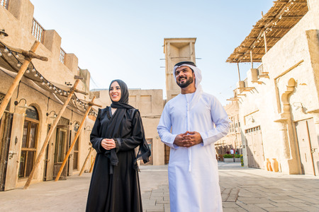 Arabian couple with traditional emirates dress dating outdoors - Happy middle-eastern couple having...