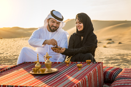 Arabian family with kids having fun in the desert - Parents and children celebrating holiday in the Dubai desrtの写真素材