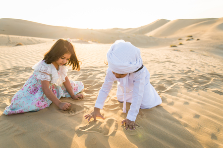 Arabian family with kids having fun in the desert - Parents and children celebrating holiday in the Dubai desrtの写真素材
