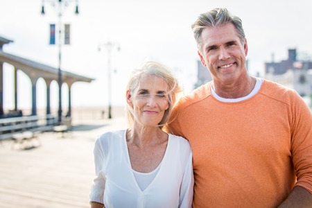 Beautiful happy senior couple dating outdoors - Youthful married couple having fun and enjoying life togetherの写真素材