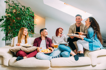 Group of happy friends bonding at home - Young adults having party and doing various activitiesの写真素材