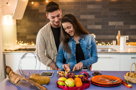 Beautiful young couple of lovers having breakfast at homeの写真素材