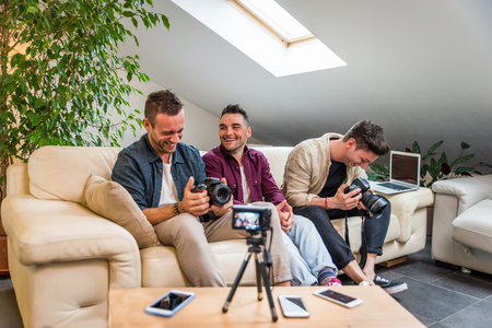 Group of social network influencers filming a vlog at home, talking and reviewing a productの写真素材