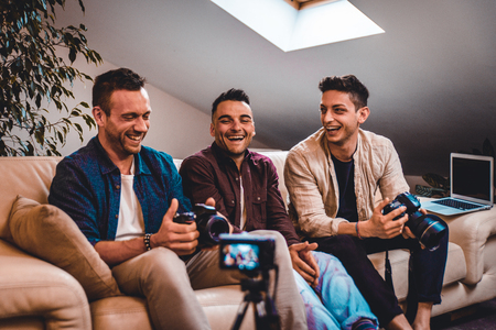 Group of social network influencers filming a vlog at home, talking and reviewing a productの写真素材