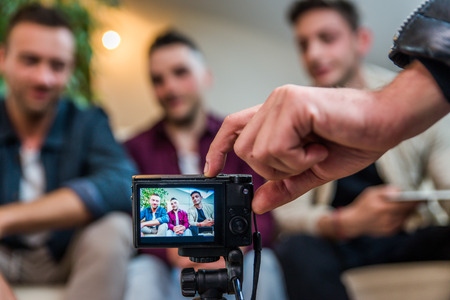Group of social network influencers filming a vlog at home, talking and reviewing a productの写真素材