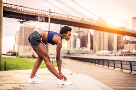 Young fitness woman running in New York - Sportive girl training outdoors, concepts about sport and healthy lifestyleの写真素材