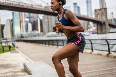 Young fitness woman running in New York - Sportive girl training outdoors, concepts about sport and healthy lifestyleの写真素材