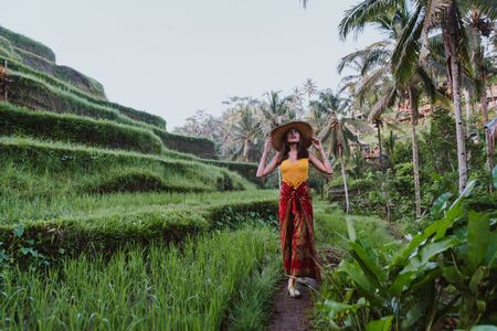 Beautiful girl visiting the Bali rice fields in tegalalang, ubud. Concept about people, wanderlust traveling and tourism lifestyleの写真素材