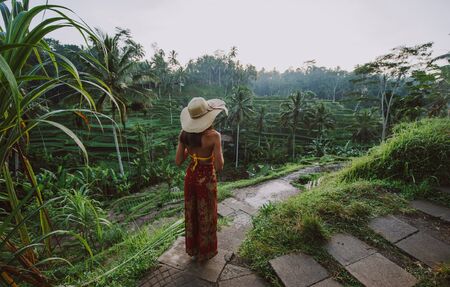 Beautiful girl visiting the Bali rice fields in tegalalang, ubud. Concept about people, wanderlust traveling and tourism lifestyleの写真素材