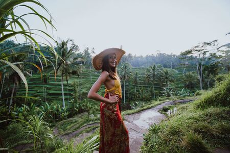 Beautiful girl visiting the Bali rice fields in tegalalang, ubud. Concept about people, wanderlust traveling and tourism lifestyleの写真素材