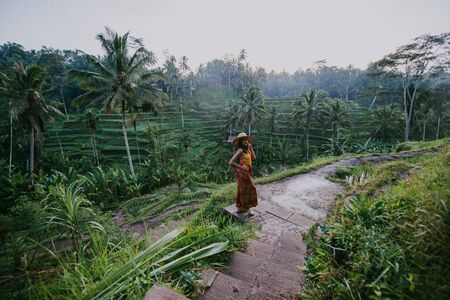Beautiful girl visiting the Bali rice fields in tegalalang, ubud. Concept about people, wanderlust traveling and tourism lifestyleの写真素材