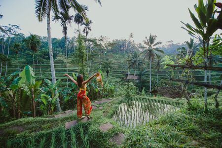 Beautiful girl visiting the Bali rice fields in tegalalang, ubud. Concept about people, wanderlust traveling and tourism lifestyleの写真素材
