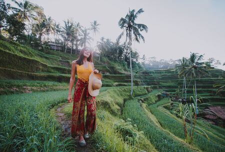 Beautiful girl visiting the Bali rice fields in tegalalang, ubud. Concept about people, wanderlust traveling and tourism lifestyleの写真素材