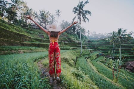 Beautiful girl visiting the Bali rice fields in tegalalang, ubud. Concept about people, wanderlust traveling and tourism lifestyleの写真素材