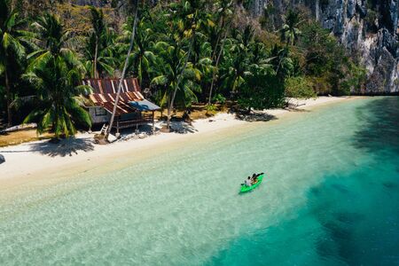Couple enjoying time kayaking in front of the beach in Coron. Concept about summer, lifestyle,wanderlust travel and natureの写真素材