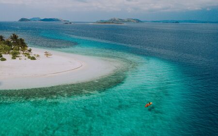 Couple spending time on a beutiful remote tropical island in the philippines. Concept about vacation and lifestyle.  kayaking and doing activitiesの写真素材