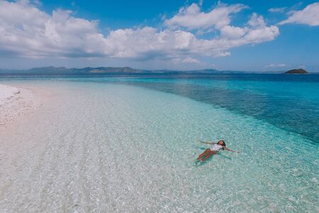 Beautiful woman enjoying the view on a tropical island in the Philippines.
