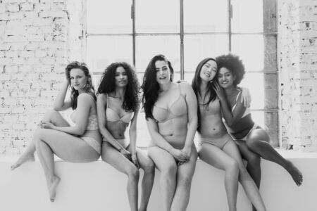 Group of women with different body and ethnicity posing together to show the woman power and strength. Curvy and skinny kind of female body conceptの写真素材