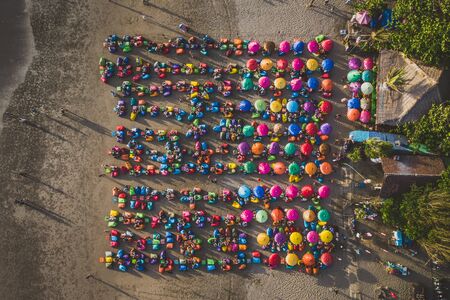 Aerial view of the beach with multicolored umbrellas and decks:の写真素材
