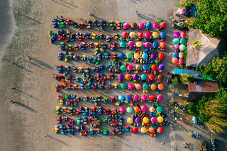 Aerial view of the beach with multicolored umbrellas and decksの写真素材