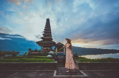 Beautiful girl visiting the ulun danu bratan temple in Bali. Concept about exotic lifestyle wanderlust travelingの写真素材
