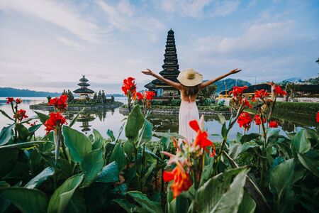Beautiful girl visiting the ulun danu bratan temple in Bali. Concept about exotic lifestyle wanderlust travelingの写真素材