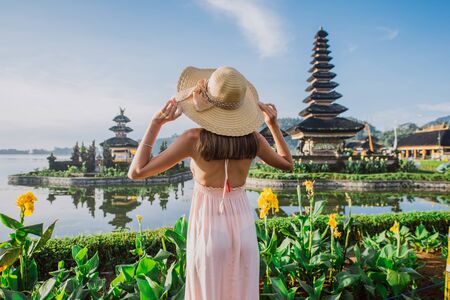 Beautiful girl visiting the ulun danu bratan temple in Bali. Concept about exotic lifestyle wanderlust travelingの写真素材