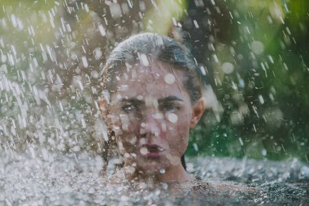 Beautiful girl relaxing in the summer rain. concept about lifestyle,beauty, vacations and real estatesの写真素材