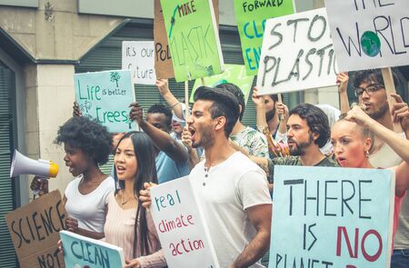 Public demonstration on the street against global warming and pollution. Group of multiethnic people...
