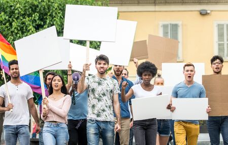 Public demonstration on the street against social problems and human rights. Group of multiethnic...