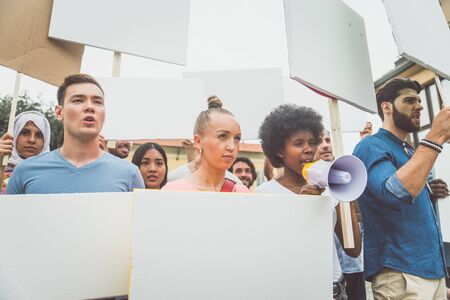 Public demonstration on the street against social problems and human rights. Group of multiethnic...