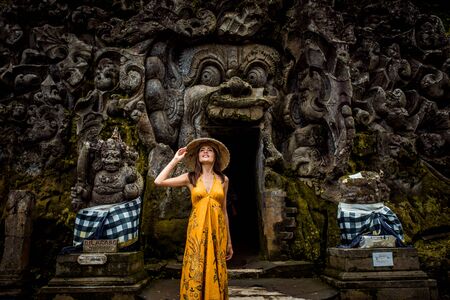 Beautiful woman in old hindu temple of Goa Gajah near Ubud on the island of Bali, Indonesiaの写真素材