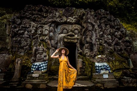 Beautiful woman in old hindu temple of Goa Gajah near Ubud on the island of Bali, Indonesiaの写真素材