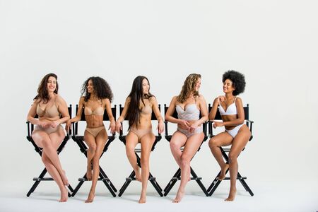 Multi-ethnic group of beautiful women posing in underwear in a beauty studioの写真素材