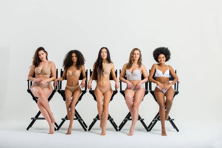 Multi-ethnic group of beautiful women posing in underwear in a beauty studioの写真素材