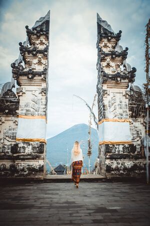 A woman at ancient gates in Pura Lempuyangの写真素材