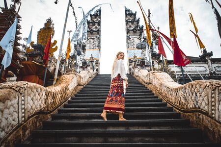 A woman at ancient gates in Pura Lempuyangの写真素材