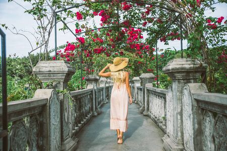 Young beautiful woman in Taman Ujung water palace, Bali island, Indonesiaの写真素材