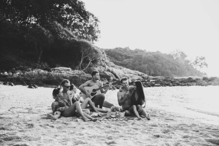 Group of friends having fun on the beach on a lonely island