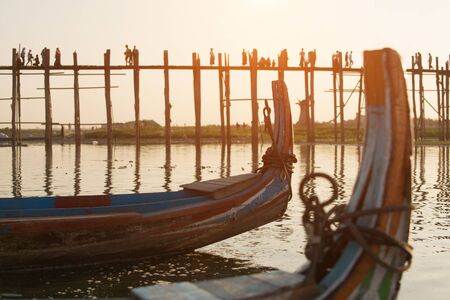 Sunset with silhouette of people walking on Bridge U-Bein in the evening, Amarapura, Mandalay,...