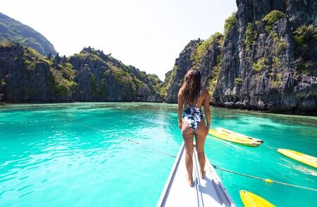 Woman kayaking in the Small Lagoon in El Nido, Palawan, Philippines - Travel blogger exploring...