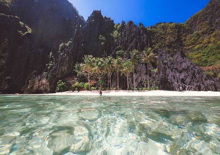 Beautiful woman on a Tropical Island with blue waterの写真素材