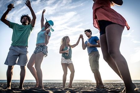 Group of friends having fun on the seashoreの写真素材